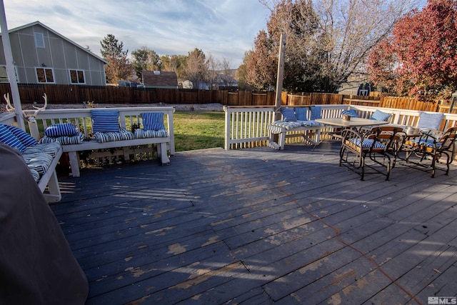 wooden deck featuring a lawn