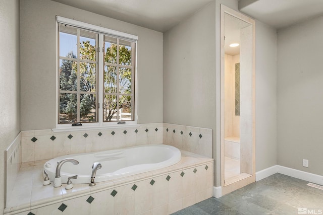 bathroom featuring a relaxing tiled tub