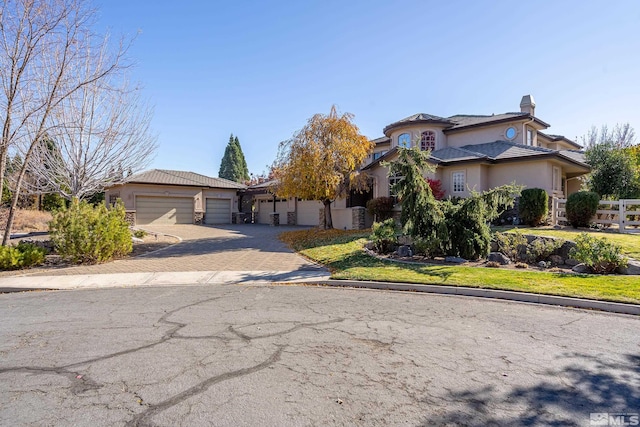 view of front of home with a front lawn and a garage