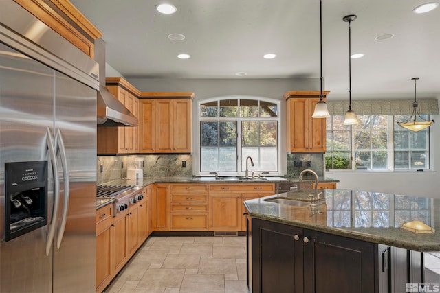 kitchen featuring a healthy amount of sunlight, appliances with stainless steel finishes, hanging light fixtures, and sink