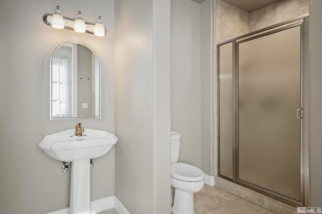 bathroom with walk in shower, tile patterned floors, and toilet