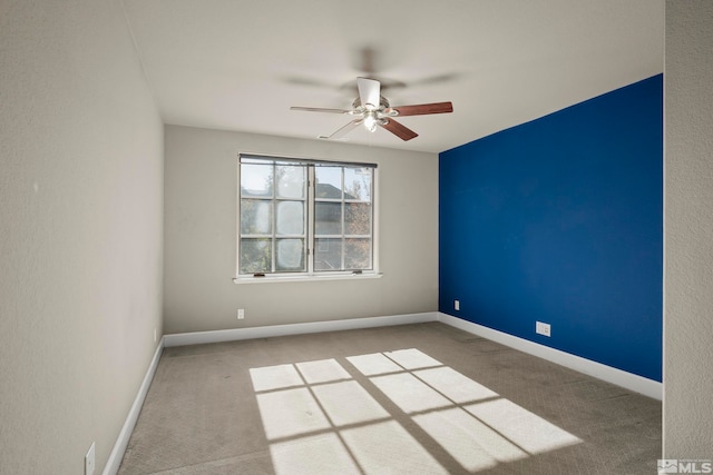 spare room featuring carpet and ceiling fan