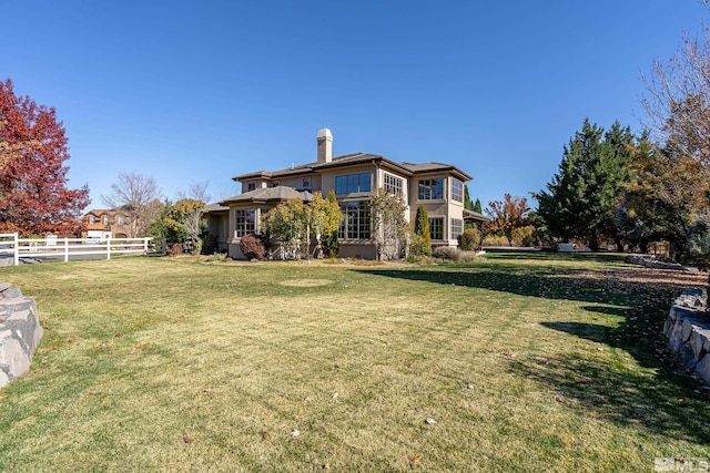 rear view of property featuring a yard