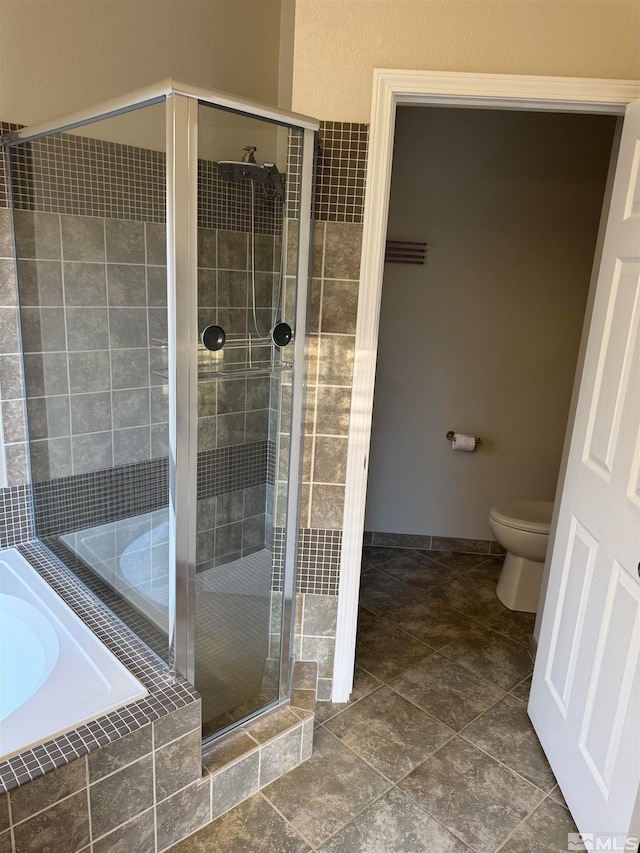 bathroom with shower with separate bathtub and toilet