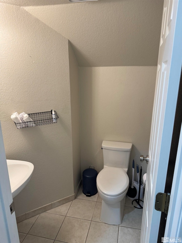 bathroom with tile patterned flooring and toilet