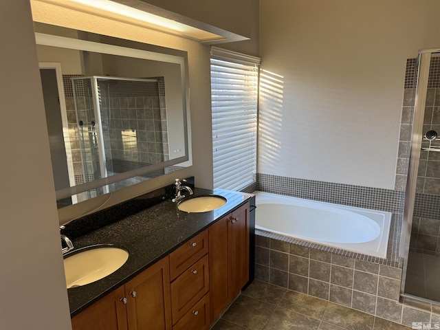 bathroom with tile patterned floors, vanity, and shower with separate bathtub