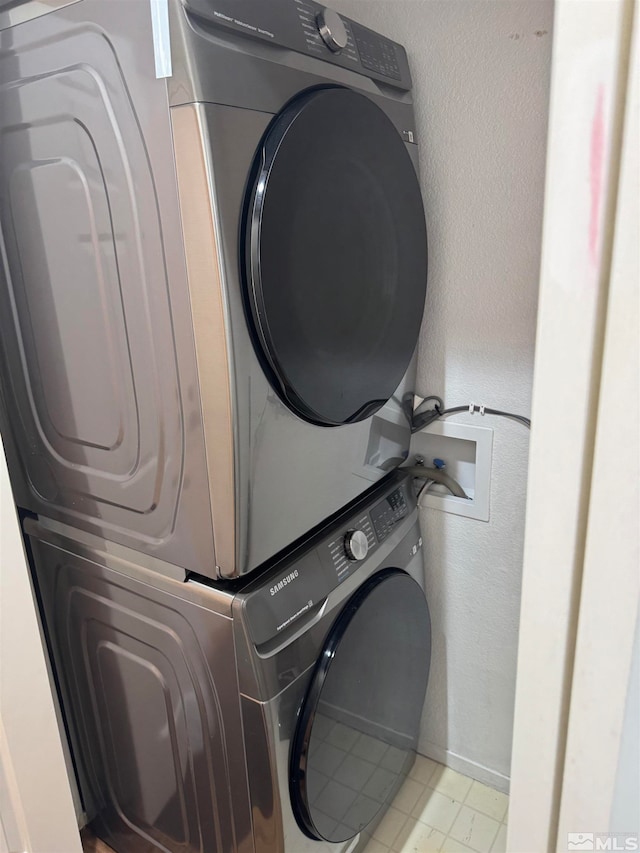 washroom featuring stacked washer and dryer