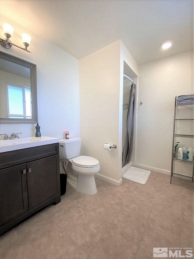 bathroom with a shower with shower curtain, tile patterned floors, vanity, and toilet