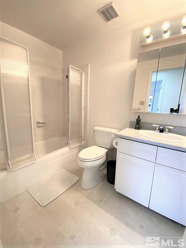 full bathroom with toilet, vanity, and tiled shower / bath