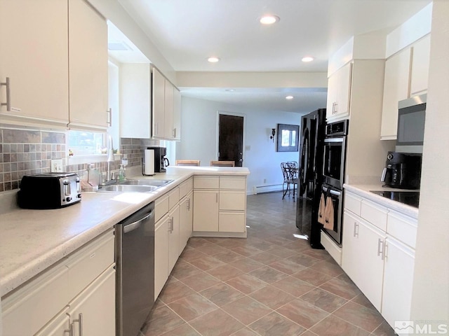 kitchen with a baseboard heating unit, white cabinets, sink, tasteful backsplash, and stainless steel appliances