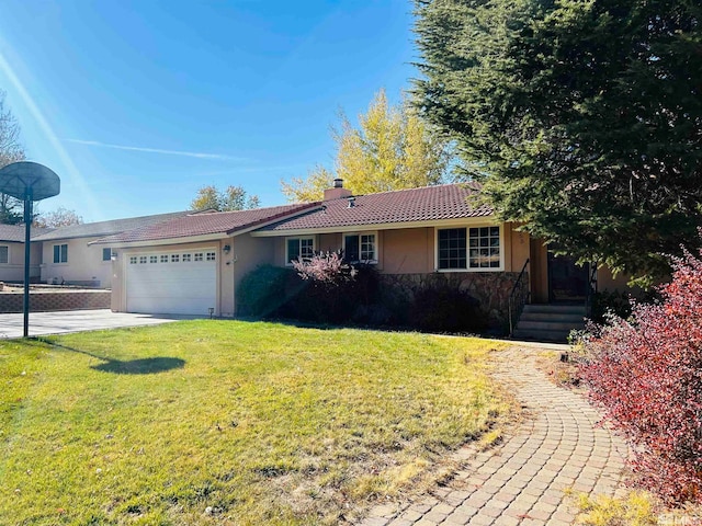 single story home with a garage and a front lawn