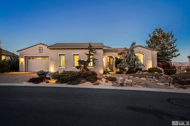 mediterranean / spanish-style house with a garage