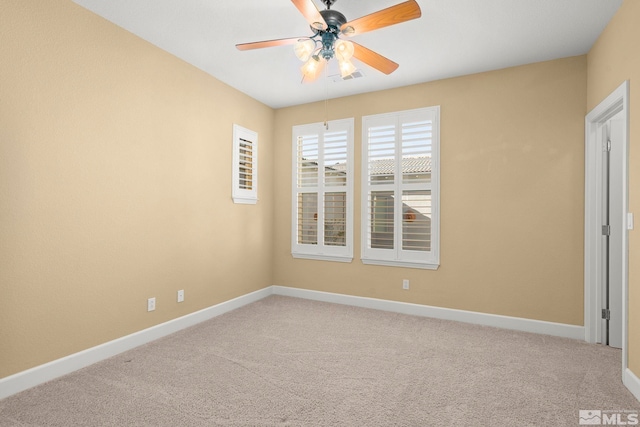 unfurnished room with ceiling fan and carpet floors