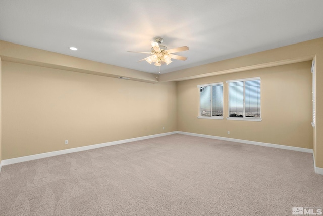 carpeted spare room with ceiling fan