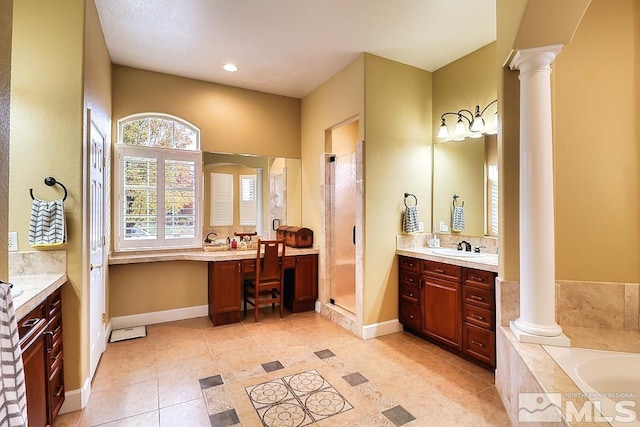 bathroom with tile patterned floors, vanity, ornate columns, and plus walk in shower