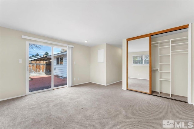 interior space with access to exterior, carpet floors, and a closet