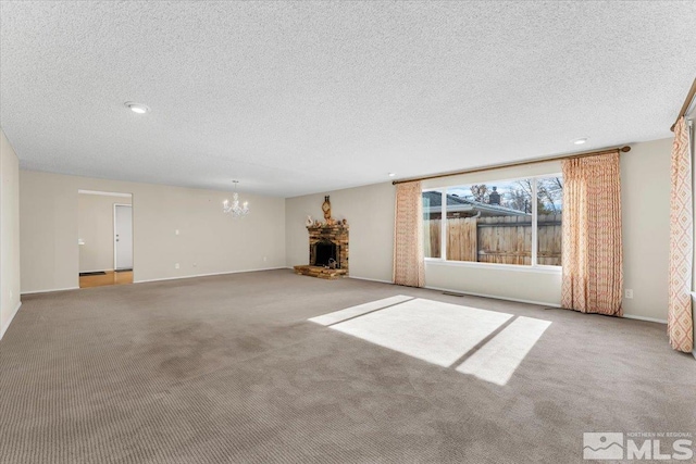 unfurnished living room with a fireplace, light colored carpet, and a textured ceiling