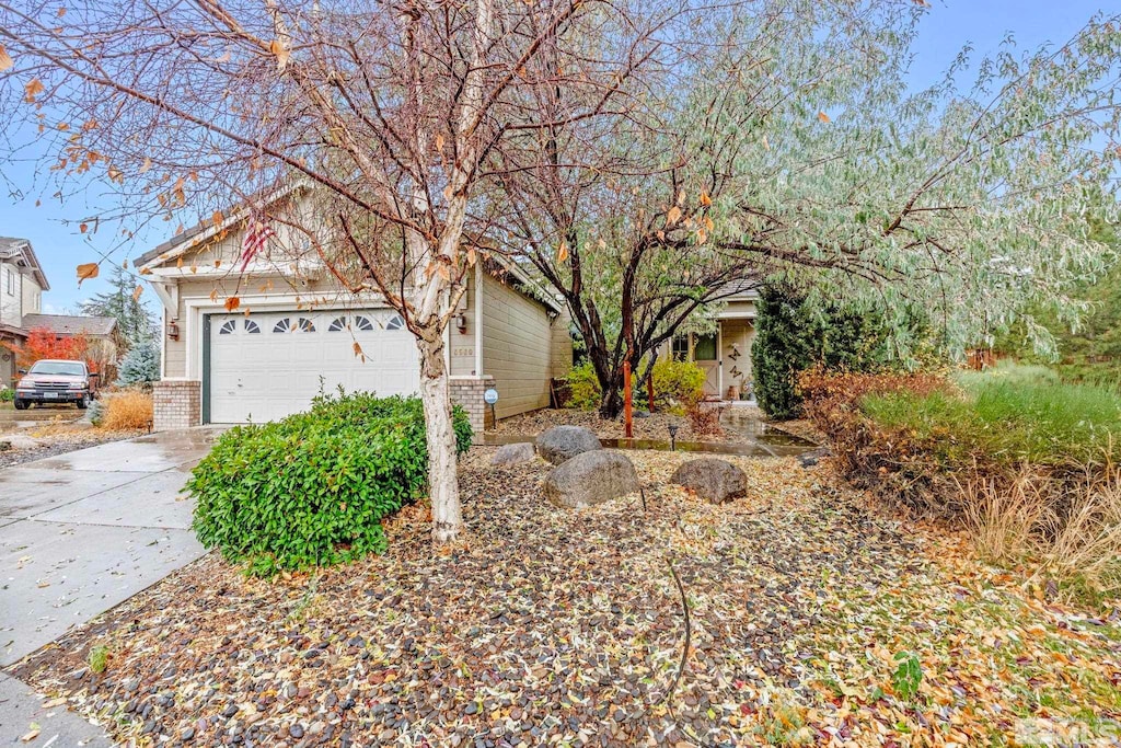 view of property hidden behind natural elements featuring a garage