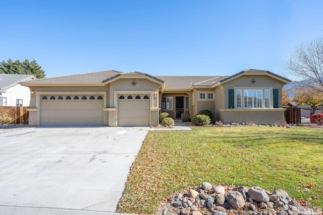 ranch-style home with a garage and a front yard