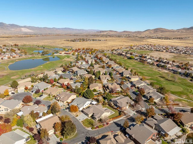 drone / aerial view with a water and mountain view