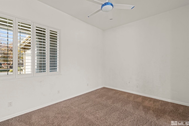 carpeted spare room featuring ceiling fan