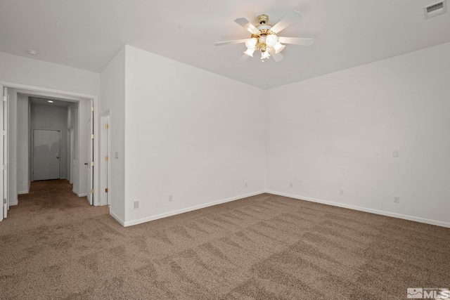 carpeted spare room with ceiling fan