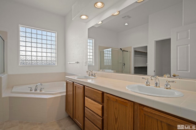 bathroom featuring vanity and separate shower and tub