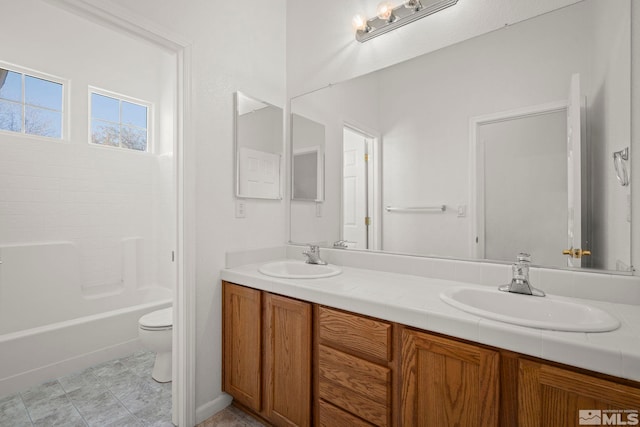 full bathroom with shower / tub combination, vanity, and toilet