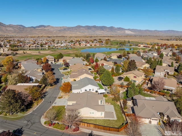 drone / aerial view with a water and mountain view