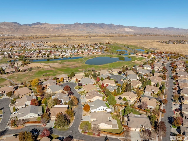 drone / aerial view featuring a water and mountain view