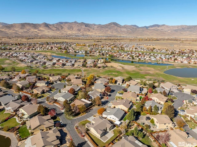 drone / aerial view with a water and mountain view