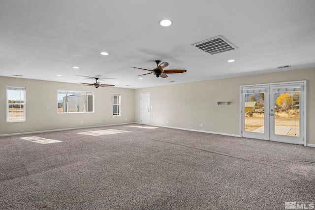 unfurnished room featuring ceiling fan, a textured ceiling, french doors, and carpet floors