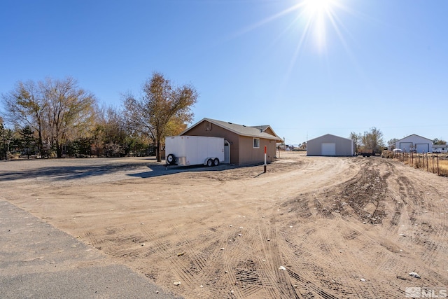 exterior space with an outbuilding and a garage