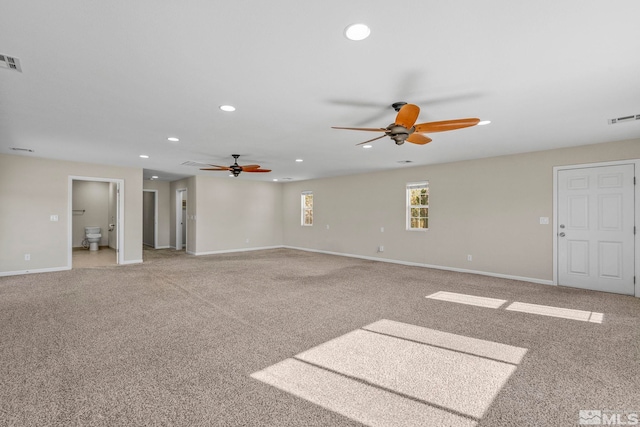 unfurnished living room featuring ceiling fan and carpet