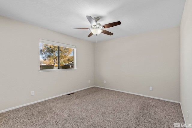 unfurnished room with ceiling fan and carpet flooring