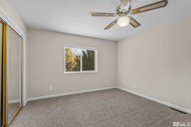 unfurnished bedroom with a closet, ceiling fan, and carpet floors