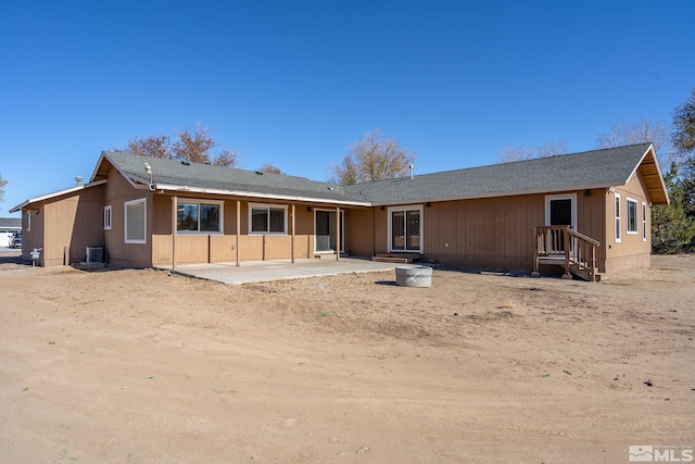 rear view of house featuring central AC unit and a patio