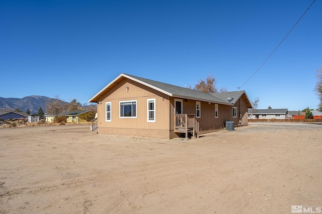 back of property featuring a mountain view and central air condition unit