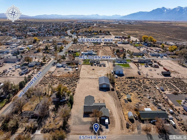 birds eye view of property with a mountain view