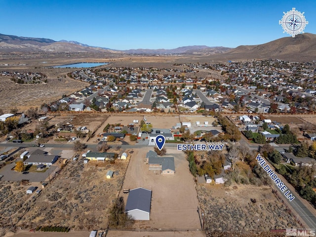 birds eye view of property with a water and mountain view