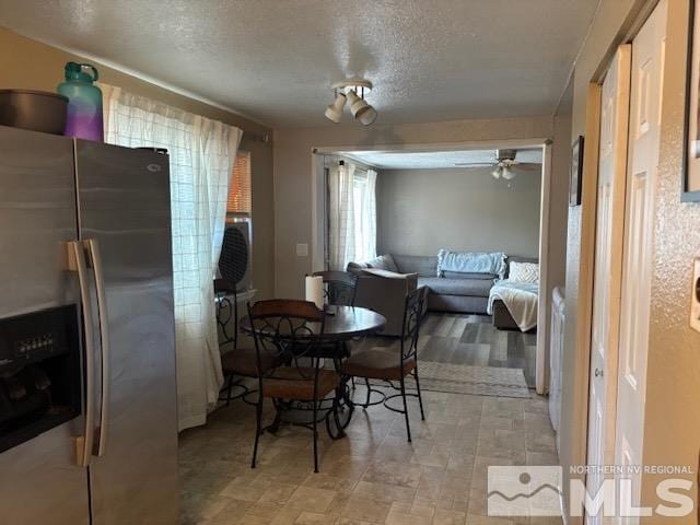 dining area with a textured ceiling and ceiling fan