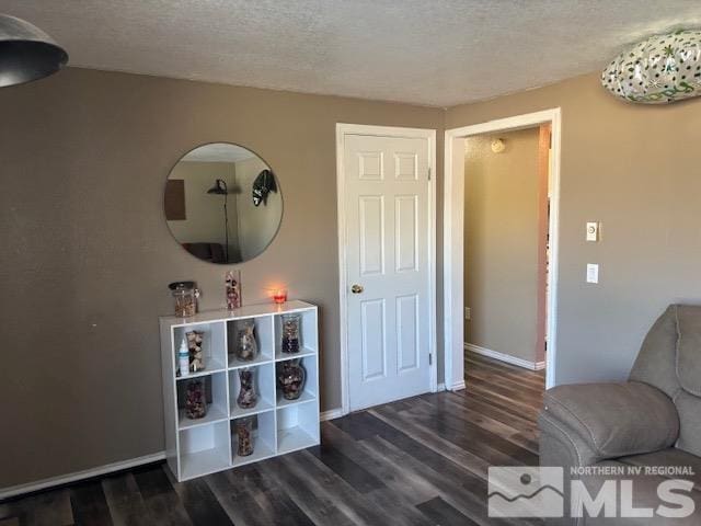 interior space featuring dark hardwood / wood-style floors and a textured ceiling