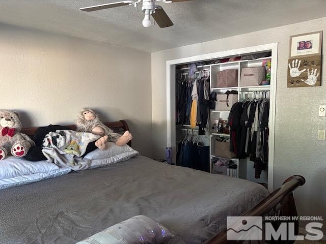 bedroom featuring ceiling fan and a closet