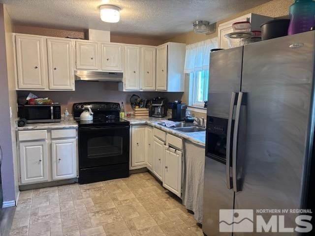 kitchen with stainless steel appliances, white cabinets, sink, and a textured ceiling