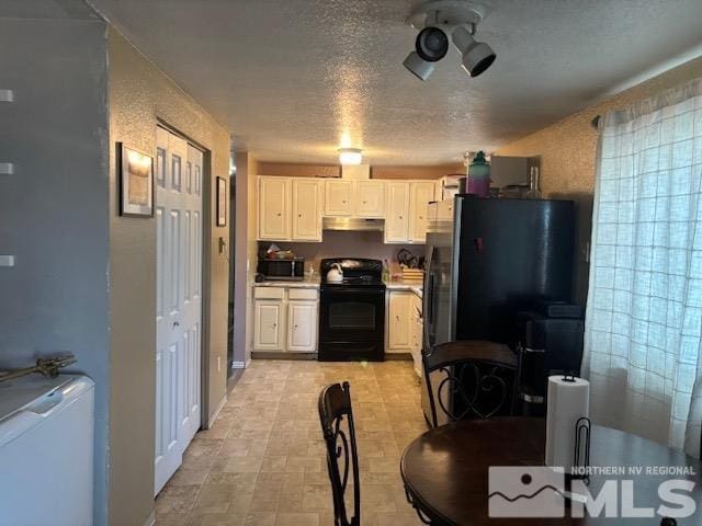 kitchen featuring refrigerator, white cabinetry, black range with electric stovetop, and a textured ceiling