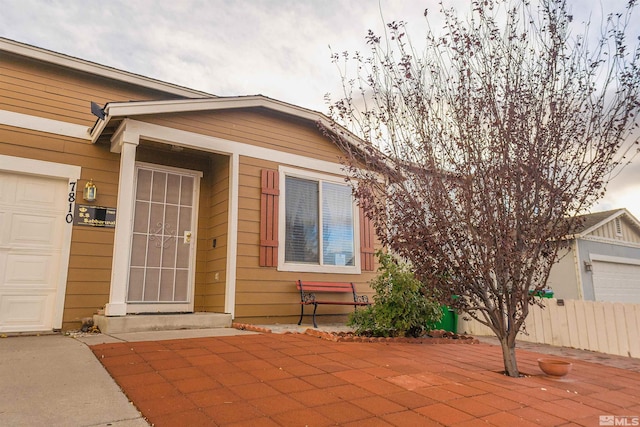 doorway to property with a garage