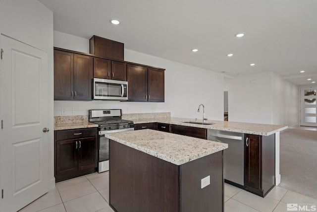 kitchen with sink, dark brown cabinets, kitchen peninsula, and appliances with stainless steel finishes