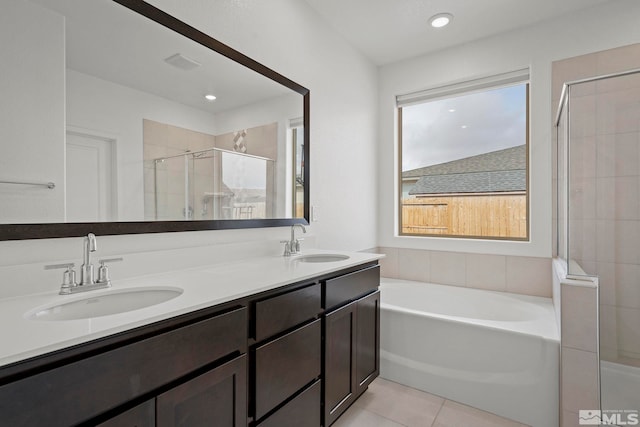 bathroom featuring independent shower and bath, tile patterned flooring, a wealth of natural light, and vanity