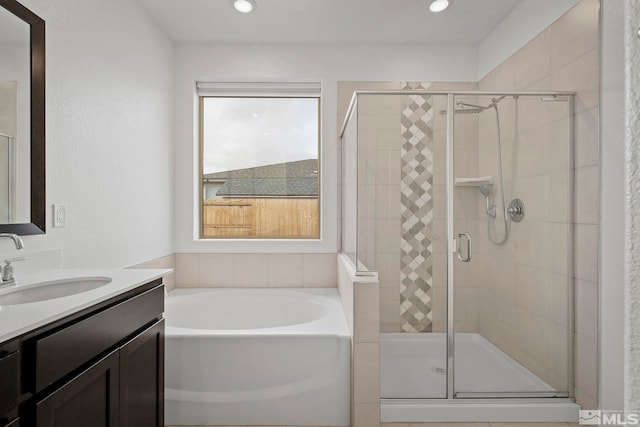 bathroom with vanity and plus walk in shower