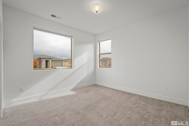 unfurnished room with light colored carpet